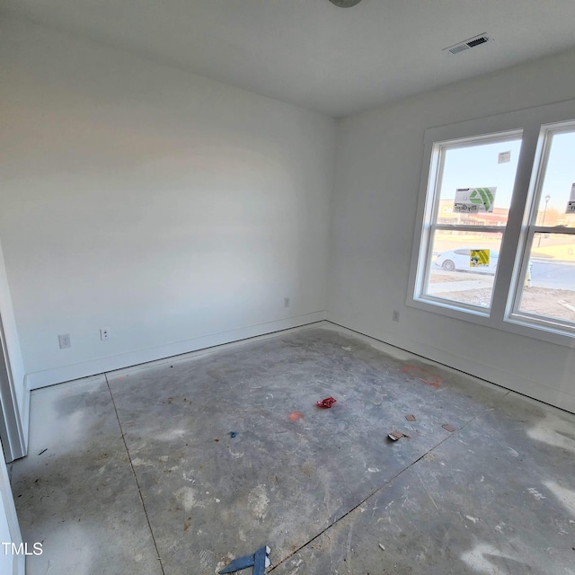 spare room with concrete flooring