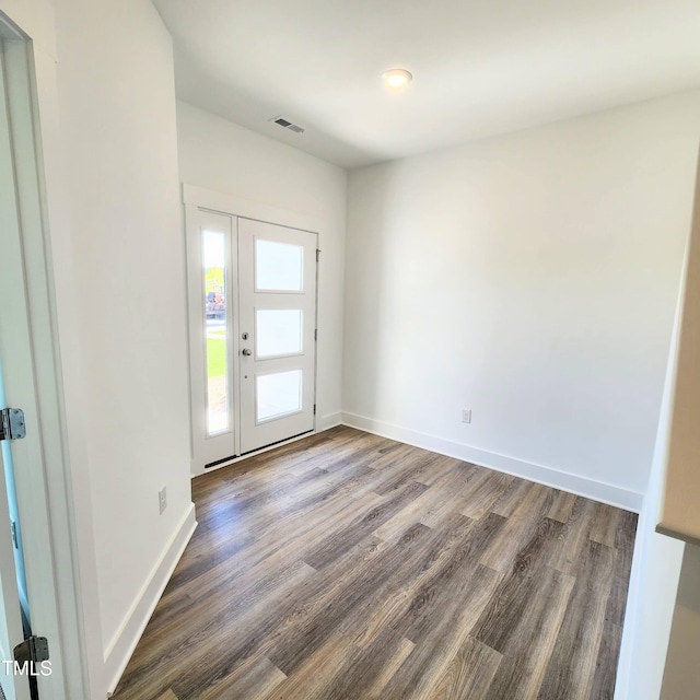 entryway with dark hardwood / wood-style flooring