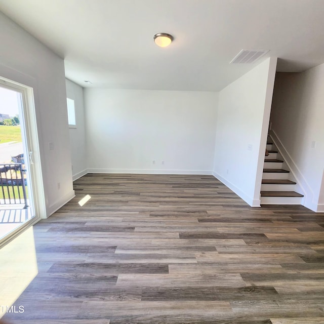 unfurnished room with dark wood-type flooring