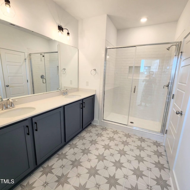 bathroom with a shower with shower door and vanity