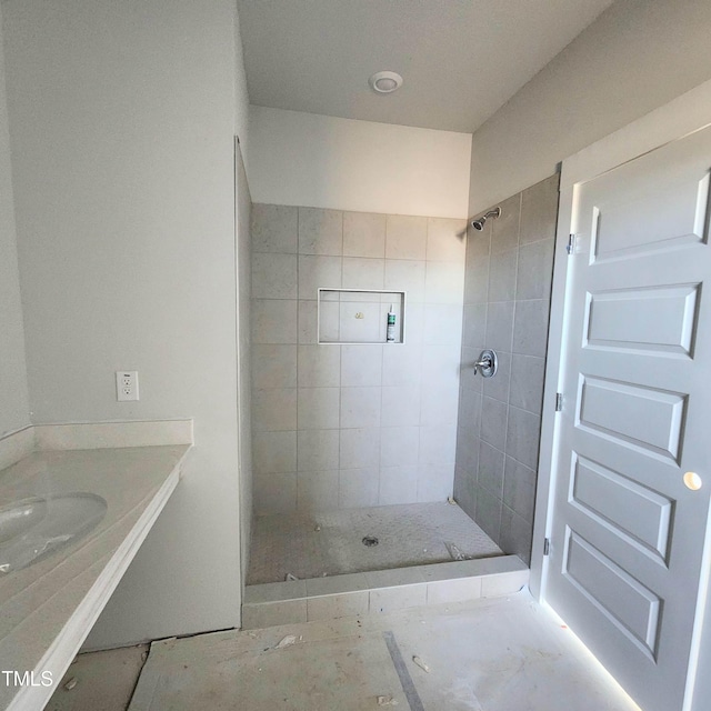 bathroom featuring vanity and a tile shower