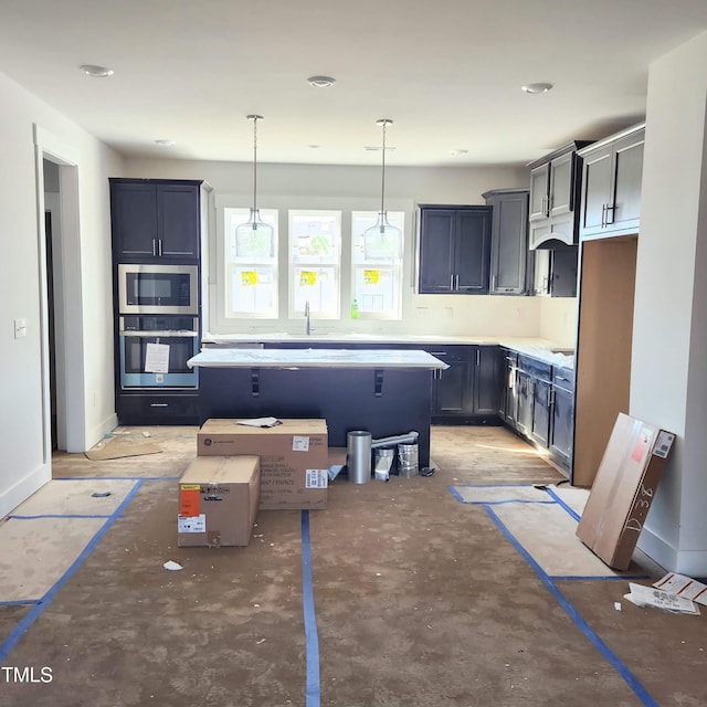 kitchen with a center island, sink, hanging light fixtures, stainless steel oven, and built in microwave