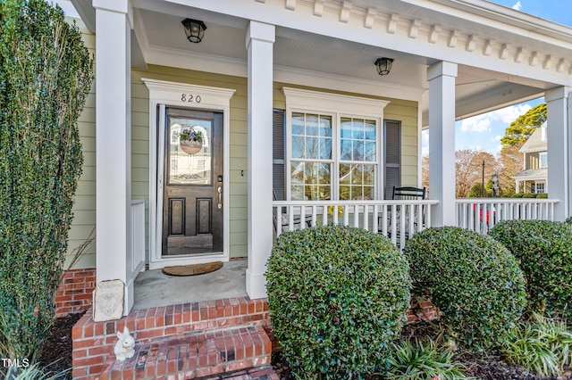 view of exterior entry with a porch