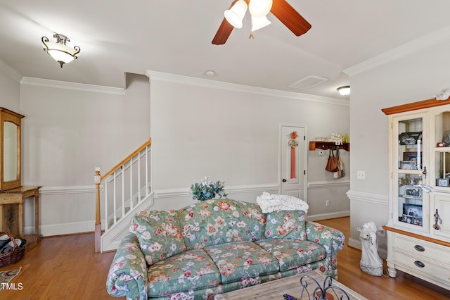 living room with ceiling fan, light hardwood / wood-style flooring, and crown molding