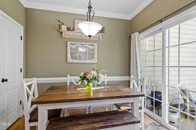 dining space featuring ornamental molding and wood-type flooring