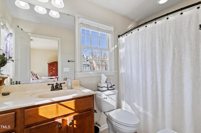 bathroom featuring toilet and vanity