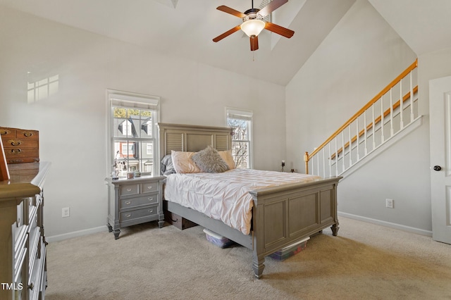 bedroom featuring ceiling fan, light carpet, and high vaulted ceiling