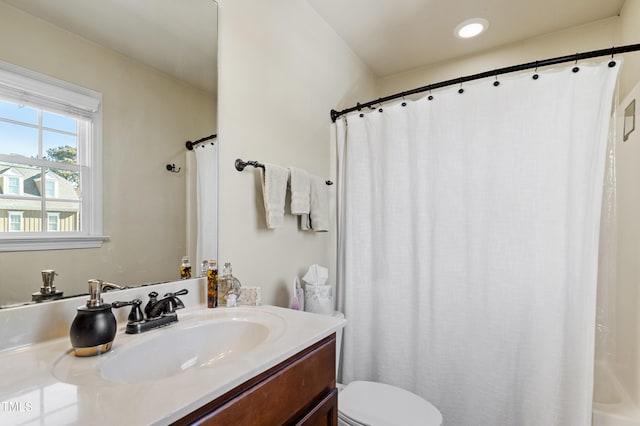 bathroom featuring toilet and vanity