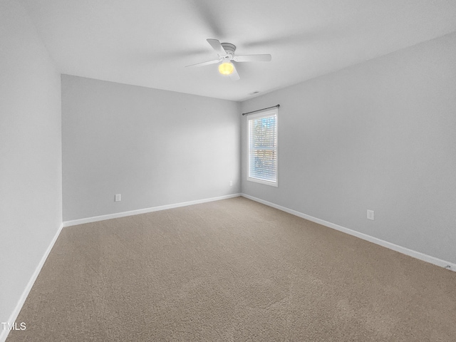 empty room with ceiling fan and carpet floors