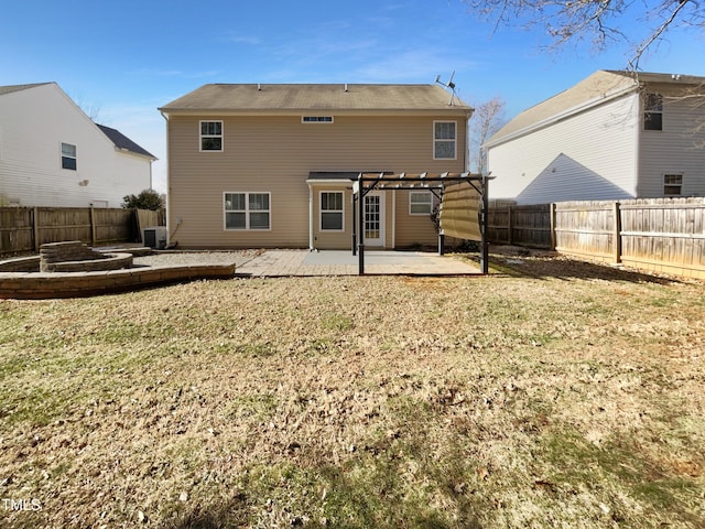 back of house featuring a lawn, central AC, a pergola, and a patio area