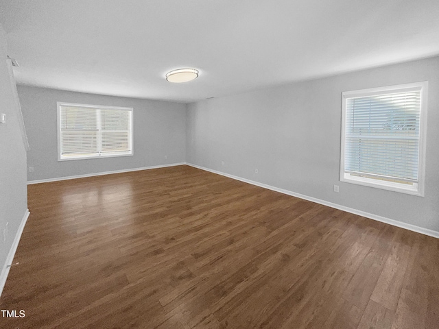 spare room featuring dark hardwood / wood-style floors