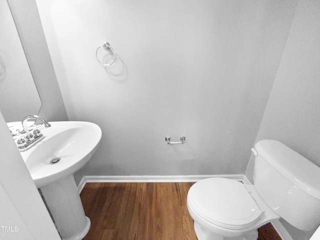 bathroom with toilet and wood-type flooring