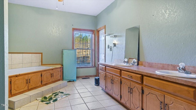 bathroom featuring tile patterned flooring, a tub to relax in, and vanity