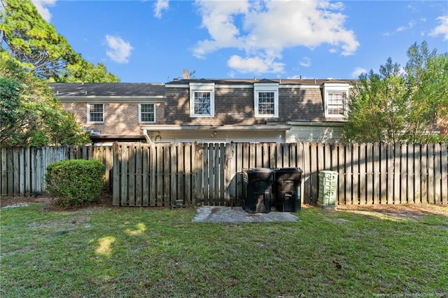 rear view of property with a yard