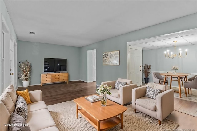 living room featuring hardwood / wood-style flooring and a chandelier