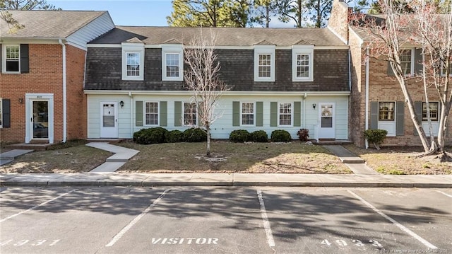 view of property with a shingled roof