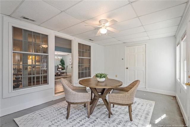 sunroom / solarium featuring a paneled ceiling, visible vents, and ceiling fan with notable chandelier