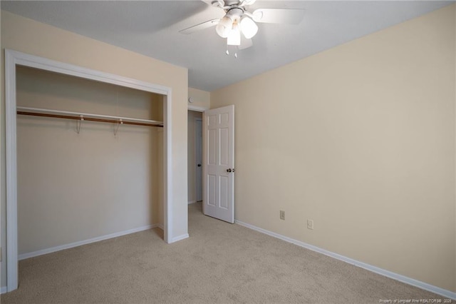 unfurnished bedroom with ceiling fan, carpet floors, a closet, and baseboards