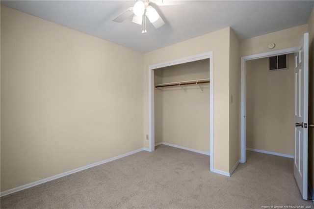 unfurnished bedroom with carpet floors, a closet, visible vents, ceiling fan, and baseboards