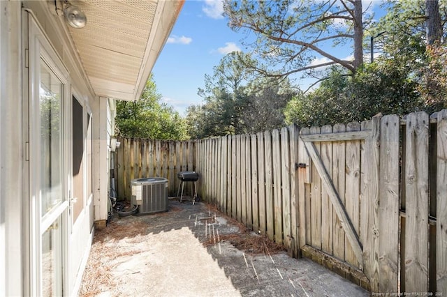 view of patio / terrace with central AC and fence