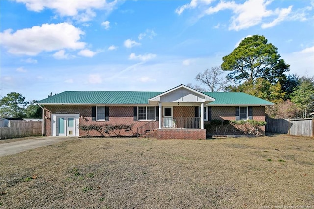 ranch-style home with a front yard, fence, concrete driveway, and brick siding