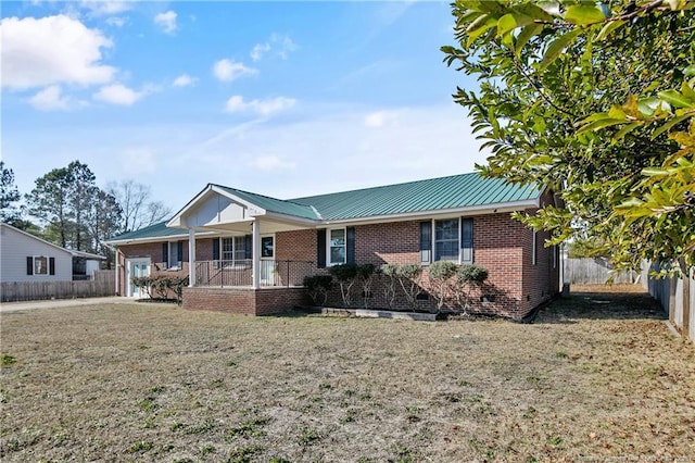 ranch-style home featuring metal roof, crawl space, fence, a porch, and brick siding