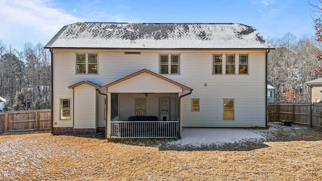 rear view of house featuring a patio and a sunroom