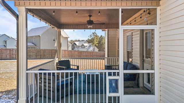 view of patio with a sunroom and ceiling fan