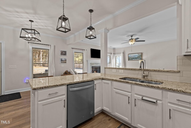 kitchen with backsplash, stainless steel dishwasher, sink, and white cabinets