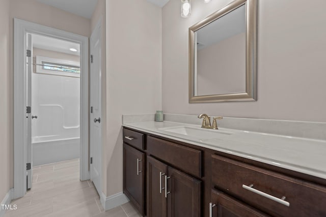 bathroom featuring vanity, tile patterned floors, and a shower