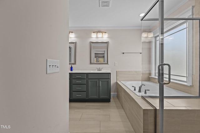 bathroom with ornamental molding, vanity, tiled bath, and tile patterned floors