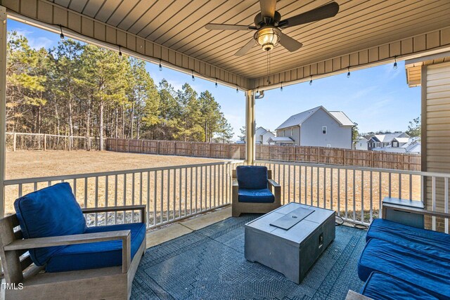 view of patio with outdoor lounge area and ceiling fan