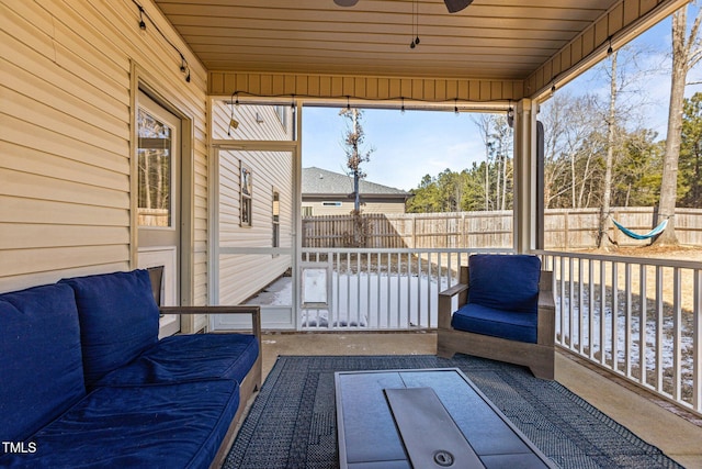 unfurnished sunroom featuring wooden ceiling and ceiling fan