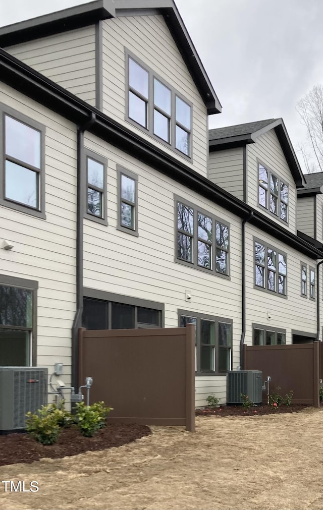 rear view of property featuring cooling unit