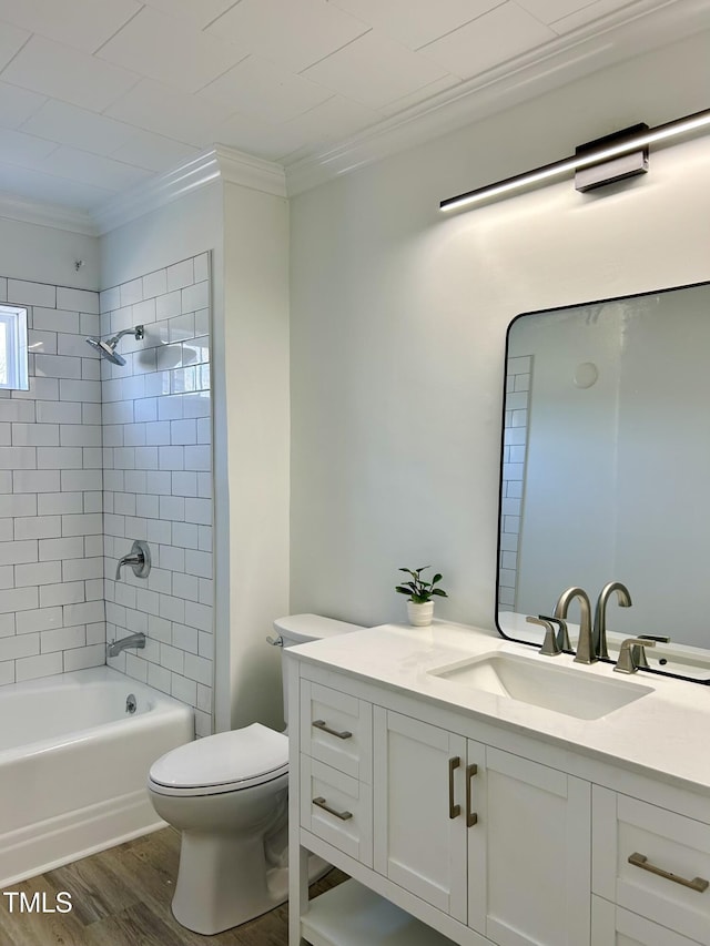 full bathroom with toilet, tiled shower / bath combo, wood-type flooring, ornamental molding, and vanity