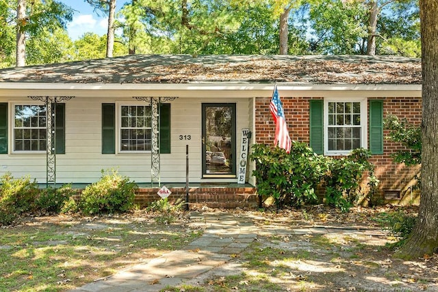 single story home featuring covered porch