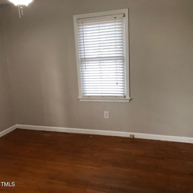 empty room featuring dark hardwood / wood-style flooring