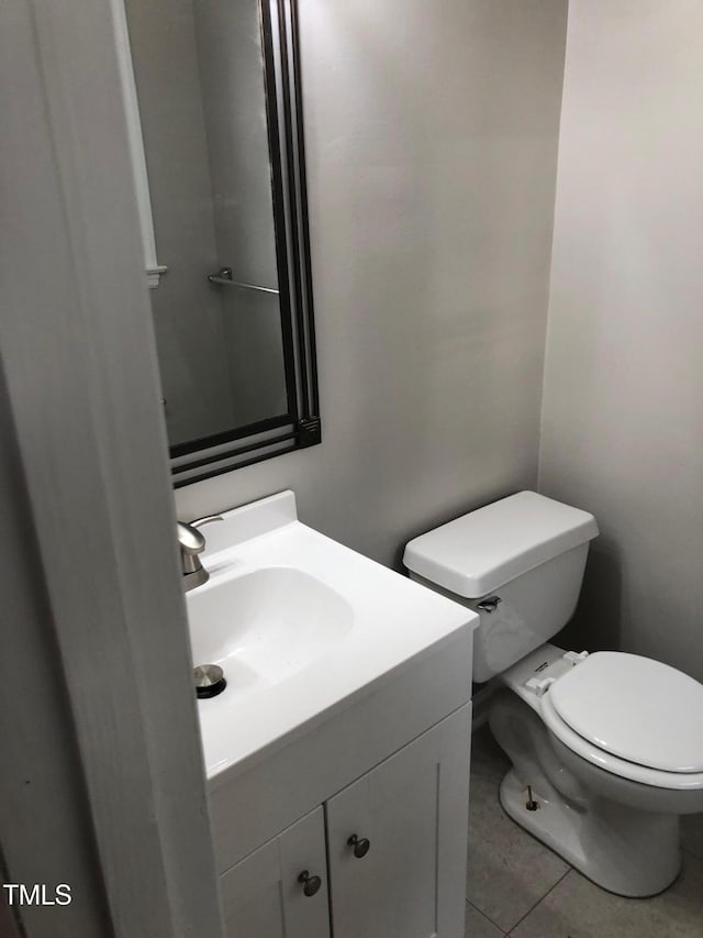 bathroom featuring vanity, tile patterned flooring, and toilet