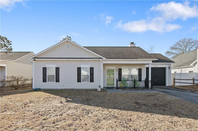 rear view of house featuring a garage and a porch