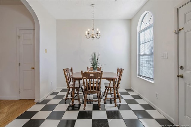 dining space featuring a wealth of natural light and a notable chandelier