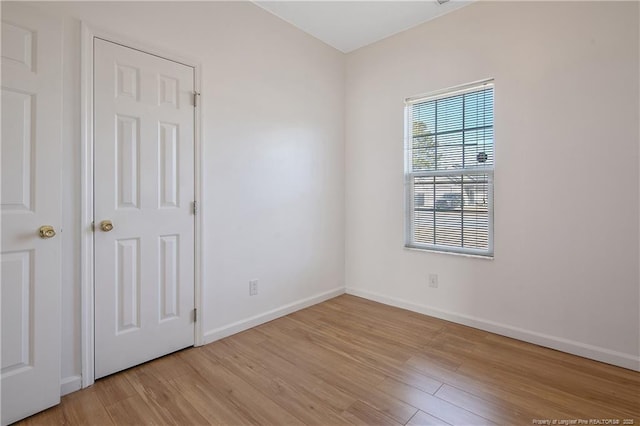 empty room with light hardwood / wood-style flooring