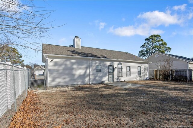 back of house with a yard