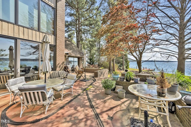 view of patio with a water view