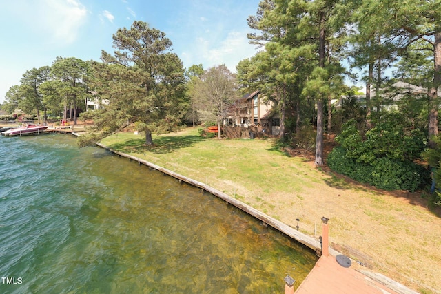 view of yard featuring a dock and a water view