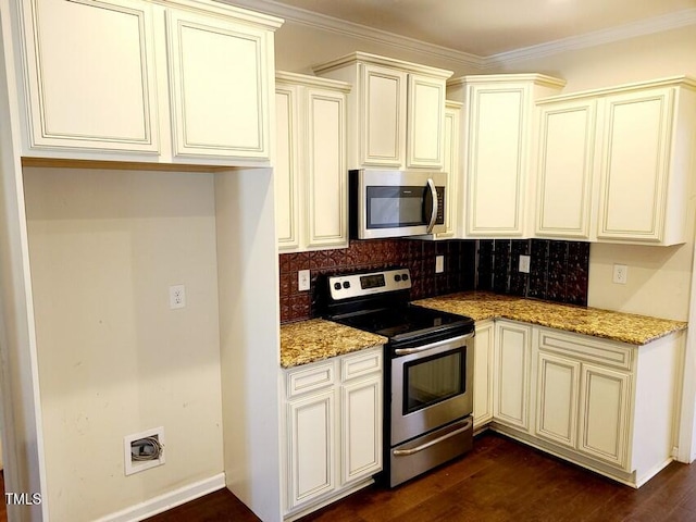 kitchen featuring cream cabinets, light stone countertops, stainless steel appliances, and ornamental molding