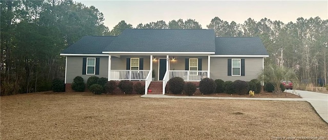 view of front of home featuring covered porch and a front yard