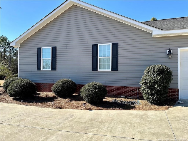 view of side of home with a garage