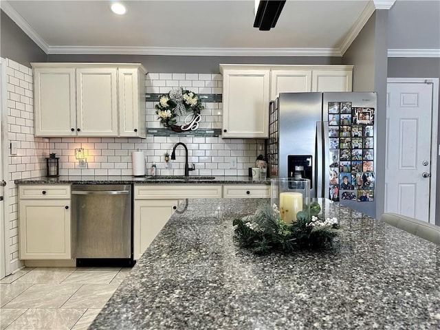 kitchen with sink, appliances with stainless steel finishes, ornamental molding, and dark stone counters