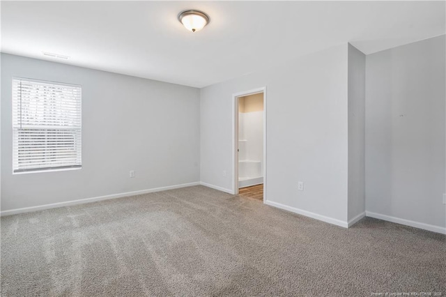 spare room featuring light colored carpet