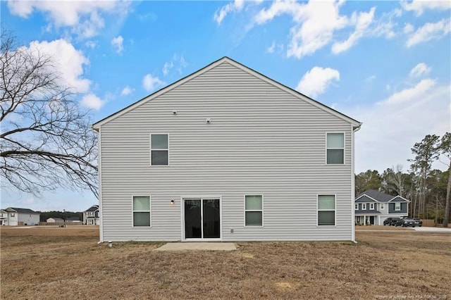 back of house featuring a yard and a patio